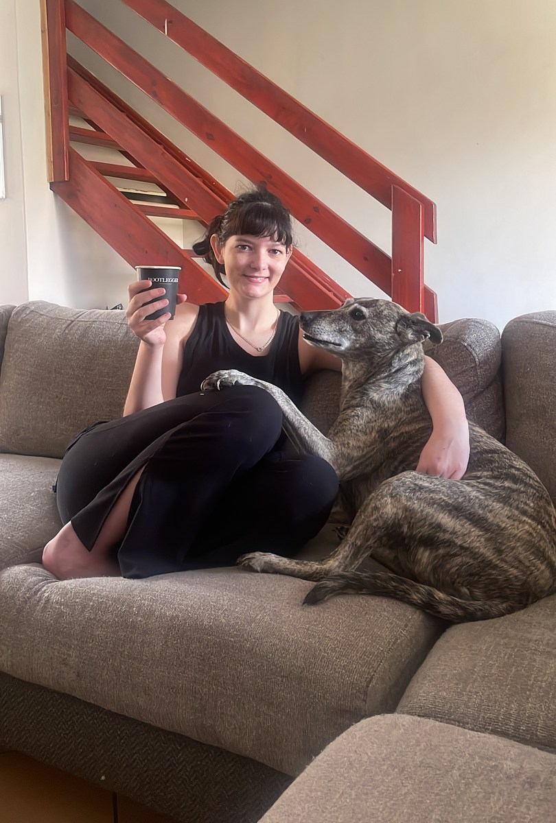 Bridget of Ease The Paw at home with her greyhound